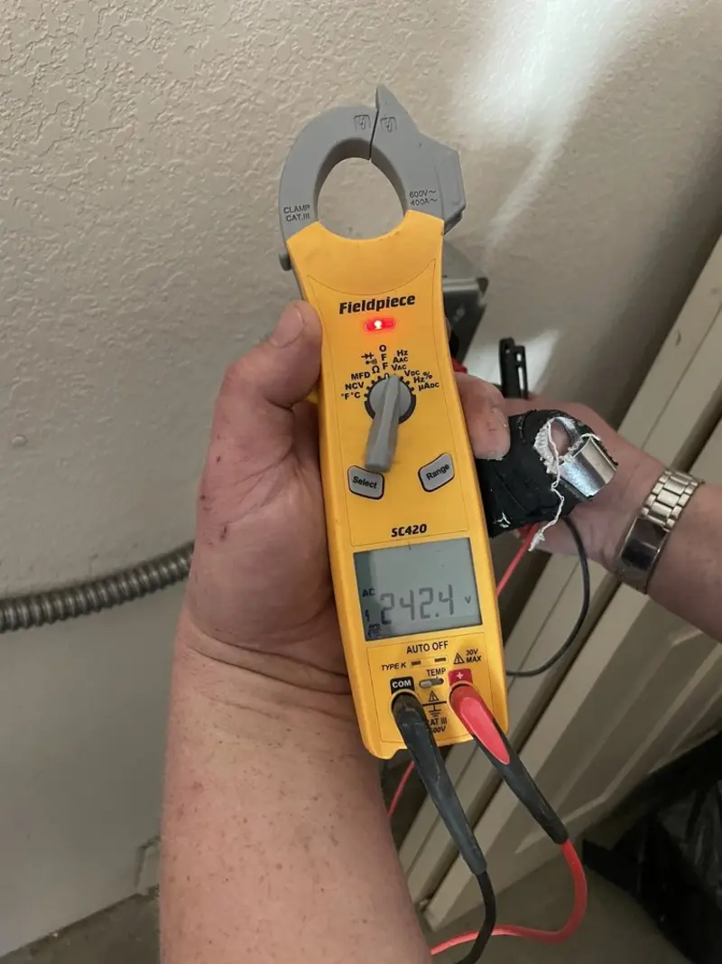 Voltage testing with clamp meter during Outlet Installation in Manchester